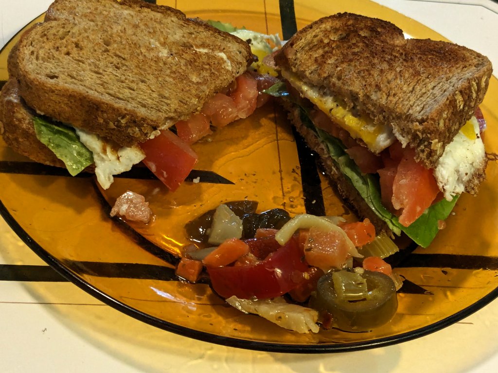 Egg, lettuce, and tomato on whole grain wheat toast and some hot giardiniera.jpg