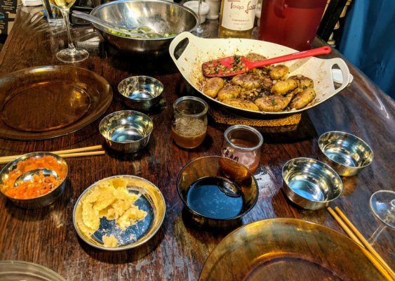 Pork and coriander dumplings, cumin potatoes, dipping sauces, and a salad.jpg