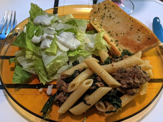Penne salsiccia, Caesar salad, and garlic bread from Monza.jpg