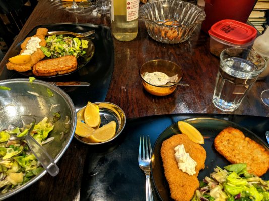 Breaded haddock, hash brown patties, remoulade, and a salad, the table small.jpg