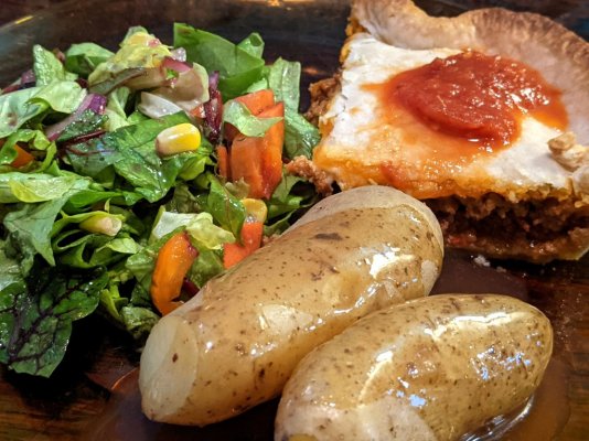 Store bought Mexican meat pie with salad, fingerling potatoes, taqueria sauce, and gravy.jpg