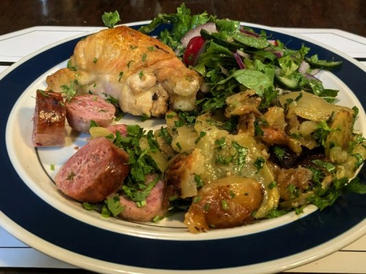 Chicken leg roasted on sliced potatoes, half a Santiago lime & cilantro sausage, and a leafy s...jpg