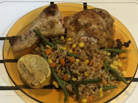 Roast chicken leg, and rice stir fried with some veggies from the freezer and roasted lemon.jpg