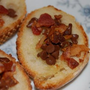 A baguette, made earlier in the day, was cut thinly and brushed with a hint of olive oil and topped with mini-chocolate chips and crispy bacon. Then i