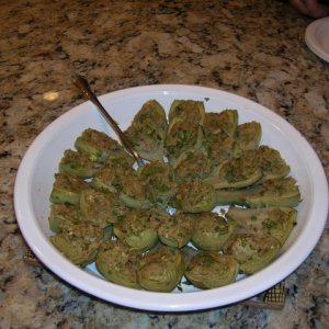 I created these by cleaning and preparing baby artichokes and then making an Italian stuffing with breadcrumbs, egg white, cheese, garlic, Parsley, S&