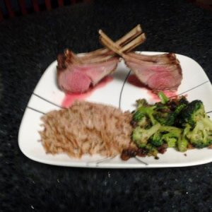 Rack of Lamb with herb crust, rice pilaf and broccoli sautéed with shallots and mushrooms.