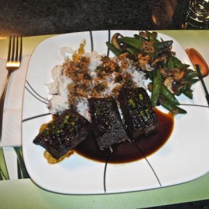 Asian-style beef short ribs with rice and sugar snap peas.