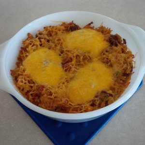 new mexican rice with eggs fried on top during baking