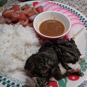 Pork Laulau dinner plate with sliced Kamaboko, Ahi Poke and steamed White Rice