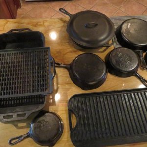 Griswold and Lodge cast iron: pots, two sided griddle, roasting pan and perforated grilling tray.