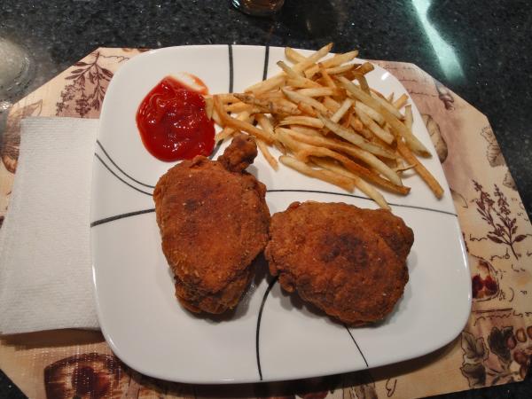 Fried chicken thighs and french fries.