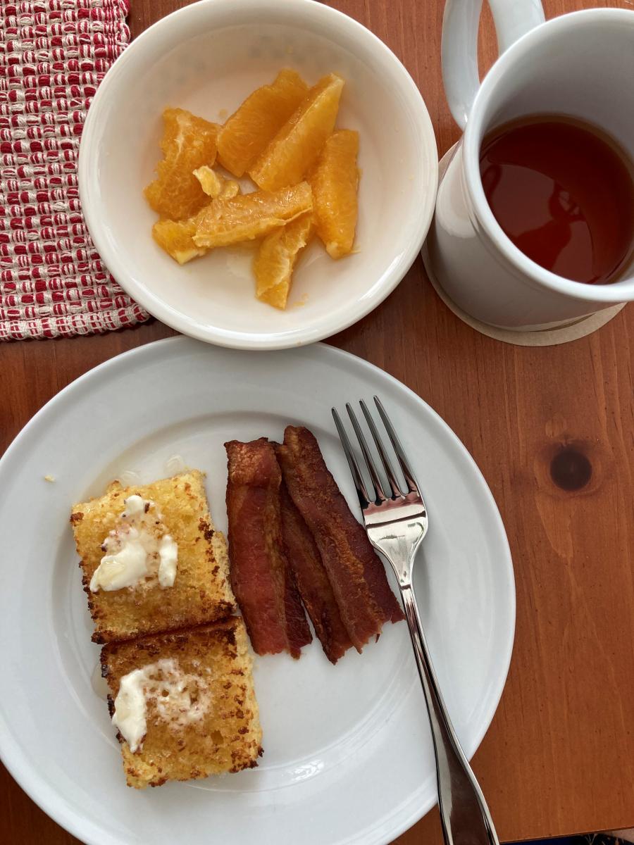 Homemade Corn Bread with loads of Butter & a goodly drizzle of local Honey.  Along some thick cut Bacon and Orange Supremes.  Oh a cuppa tea to wash i